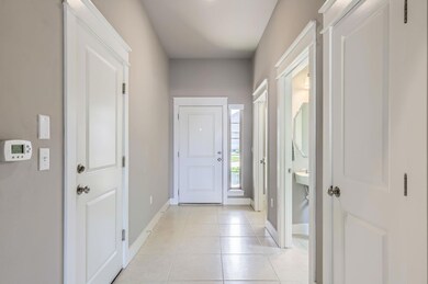 Foyer featuring baseboards and light tile pattern