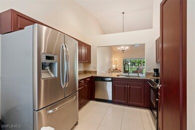 Kitchen featuring vaulted ceiling, stainless steel