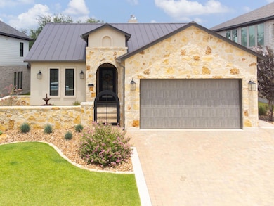 French country home with a standing seam roof, a 