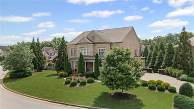 View of front of house featuring a front lawn, a standing seam roof, and driveway