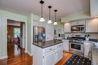Hardwood floors flow through most of the main floor and kitchen with white kitchen cabinets and stainless steel appliances and white trim!