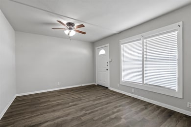Entryway with baseboards, dark wood-style flooring