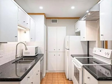 Kitchen featuring white appliances, backsplash, a
