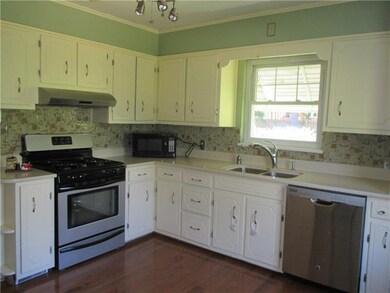Kitchen with Corian countertops and glass backspla
