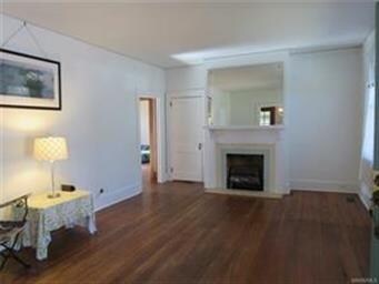 Large living room with fireplace and gas logs.