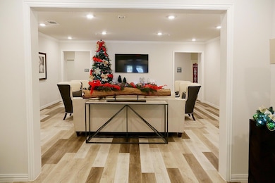 Living room with crown molding and light wood-type