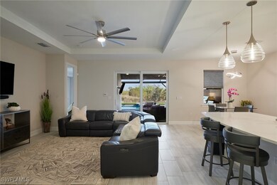 Living room with tray ceiling and ceiling fan