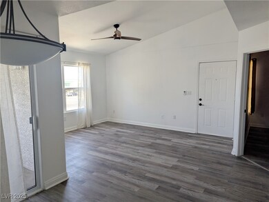 Living room featuring a ceiling fan, new wood-styl