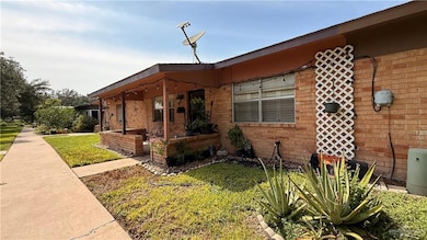 View of front of house with brick siding and a front yard