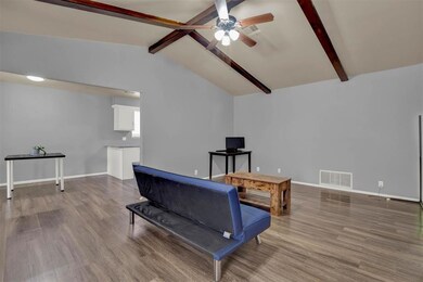 Living room with wood-type flooring, lofted ceilin