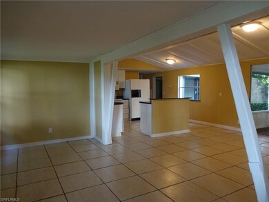 A VIEW FROM FRONT ENTRY STANDING IN THE DEN, AND LOOKING INTO THE LIVING ROOM AND OPEN KITCHEN.