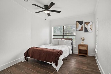 Bedroom featuring crown molding, dark wood-type fl