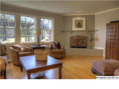 Large den, with corner fireplace, located just off