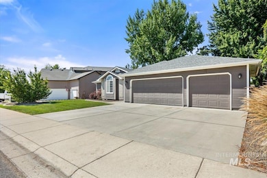 Ranch-style house featuring a front yard, a shingled roof, and a garage
