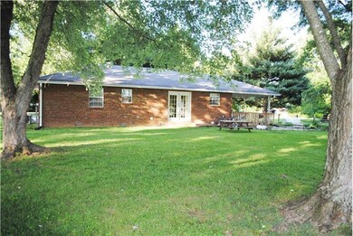 Mature trees on this almost 1 acre property.  Back yard includes 2 storage buildings.