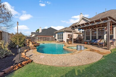 In addition to this gorgeous 18K gallon pool and covered patio there is also plenty of green space for pets.