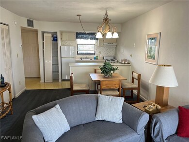 Living room with a chandelier, sink, and light har