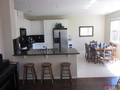 This view of the kitchen shows the breakfast bar a