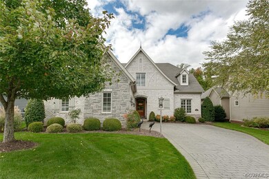French country inspired facade with a front lawn