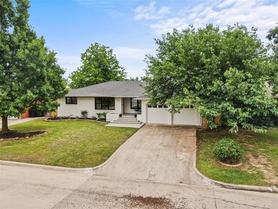Ranch-style home featuring concrete driveway, a front lawn, an attached garage, and roof with shingles