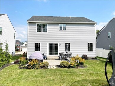 Back of house featuring a yard and a stamped patio