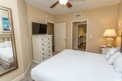 Carpeted bedroom featuring baseboards and a ceiling fan