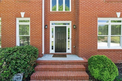 View of exterior entry with brick siding