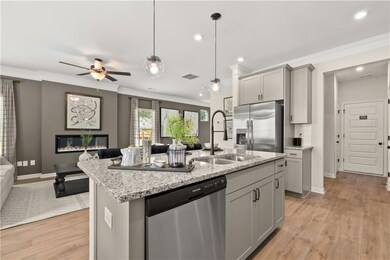 Kitchen featuring a center island with sink, stain