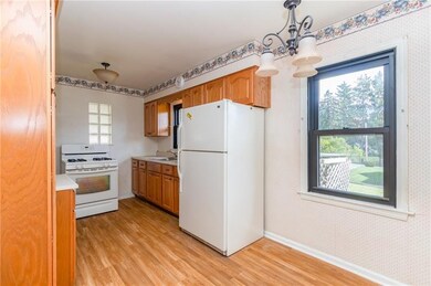 Kitchen area with laminate flooring and plenty of 