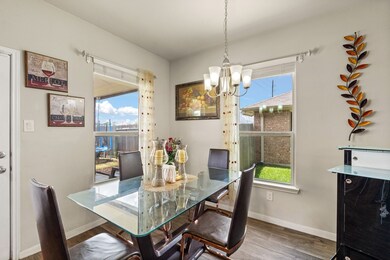 The charming breakfast area offers a delightful view of the backyard, perfect for enjoying your morning coffee.