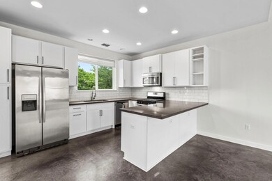 Kitchen with finished concrete flooring, applianc