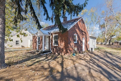 Bungalow featuring brick siding and a chimney
