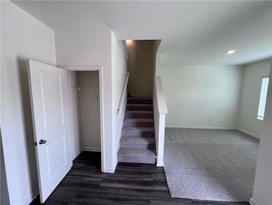 Stairway featuring wood finished floors and baseboards
