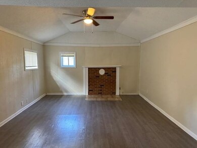 Unfurnished living room with ceiling fan, ornament