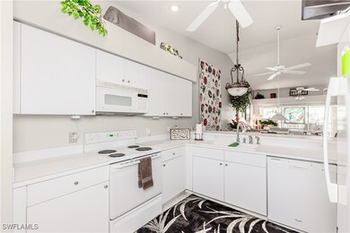 Kitchen featuring a sink, white appliances, ceilin