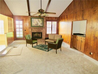 sunken living room with vaulted ceilings