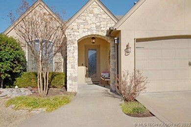 Beautiful stone and stucco exterior with covered f