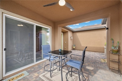 View of patio featuring a ceiling fan and outdoor