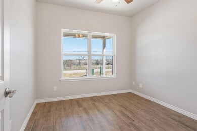 Empty room with ceiling fan, wood finished floors