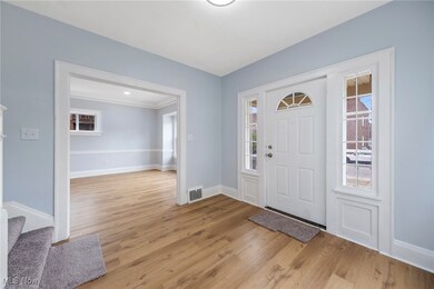Foyer with light wood-type flooring and plenty of natural light