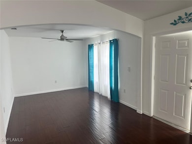 Spare room with dark wood-style floors, a ceiling