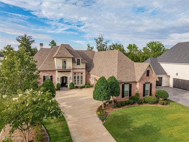 French country home with a balcony, a garage, and 