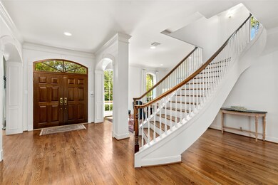 Large entry way with sweeping staircase.