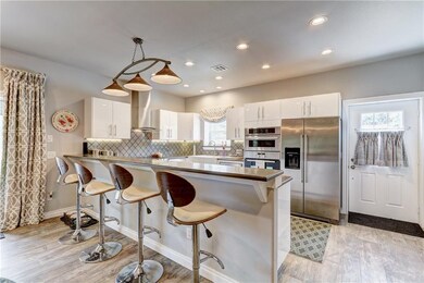 A gourmet kitchen features double ovens, convectio
