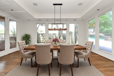 Step into elegance with this dining
room, featuring a stunning view of
the outdoor BBQ area through
large picture windows. Perfect for
entertaining, the room is accented
with a chic chandelier and
contemporary wall finishes,
seamlessly blending indoor and
outdoor living.