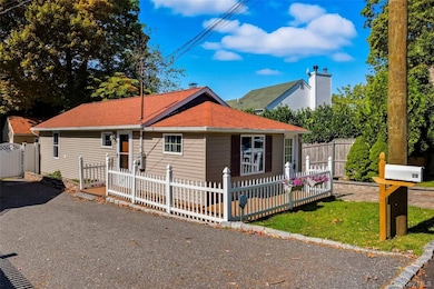 View of front of home with roof with shingles and a deck