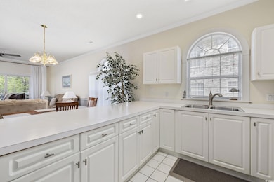 Kitchen featuring open floor plan, light counterto