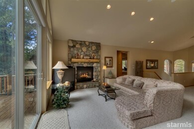 Living room with wall of windows, vaulted ceilings