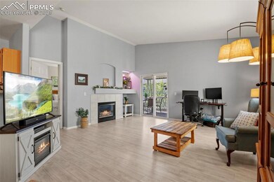 Living area featuring high vaulted ceiling, light wood-type flooring, and a tile fireplace
