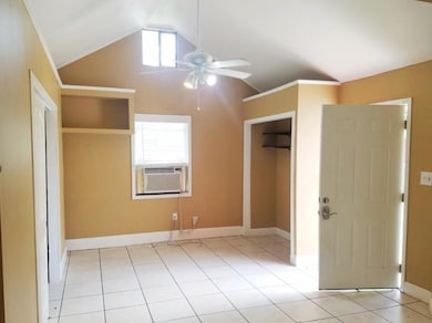 Unfurnished bedroom featuring vaulted ceiling, co